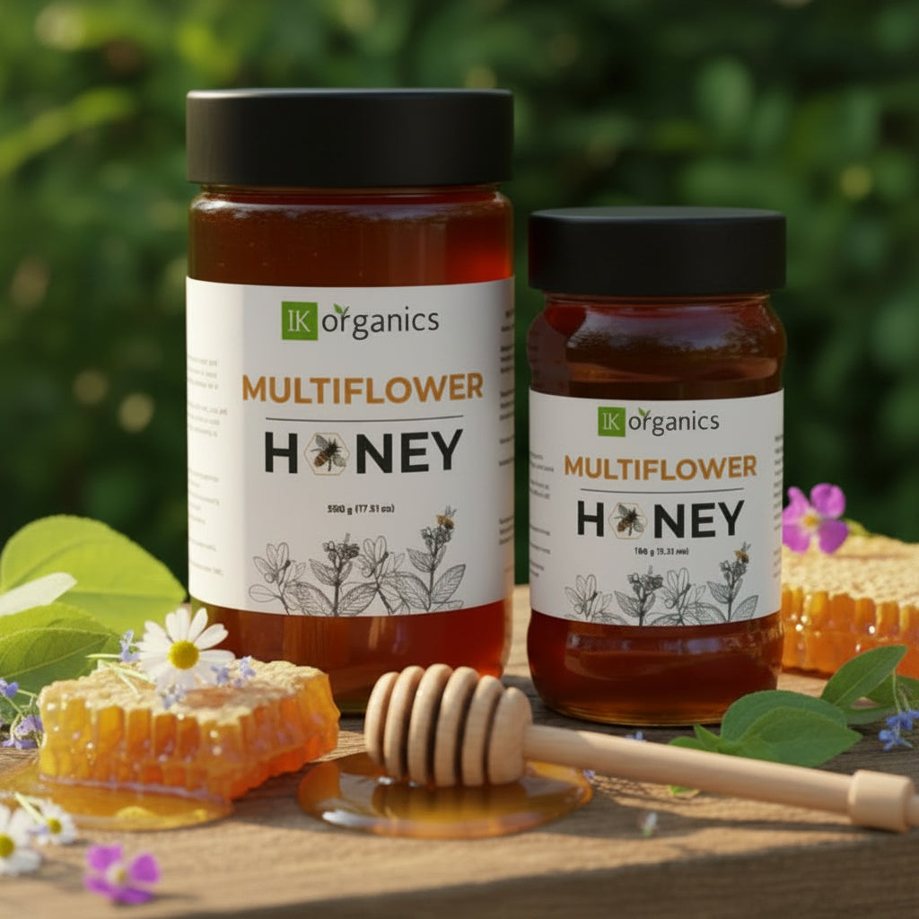 Multiflower forest honey by IK Organics on a natural background with a honey dip stick and multiple flowers